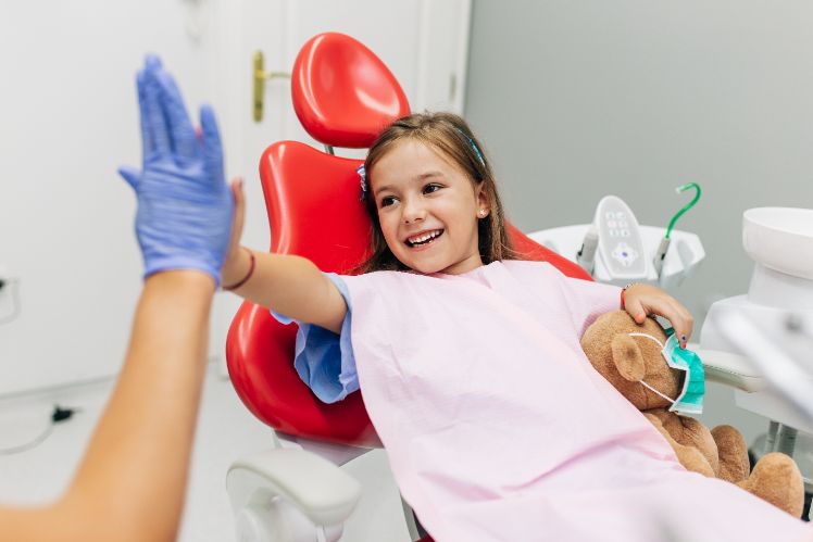Child giving high-five to Dentist