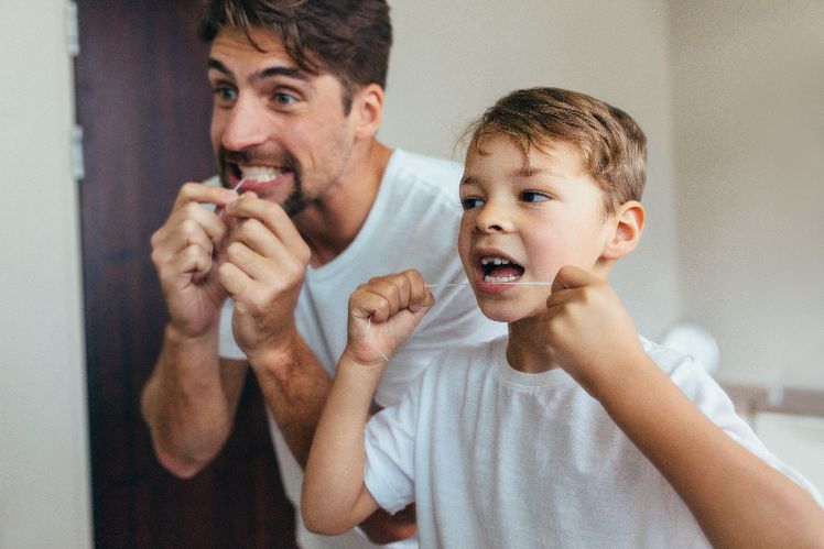 Father & son brushing teeth together